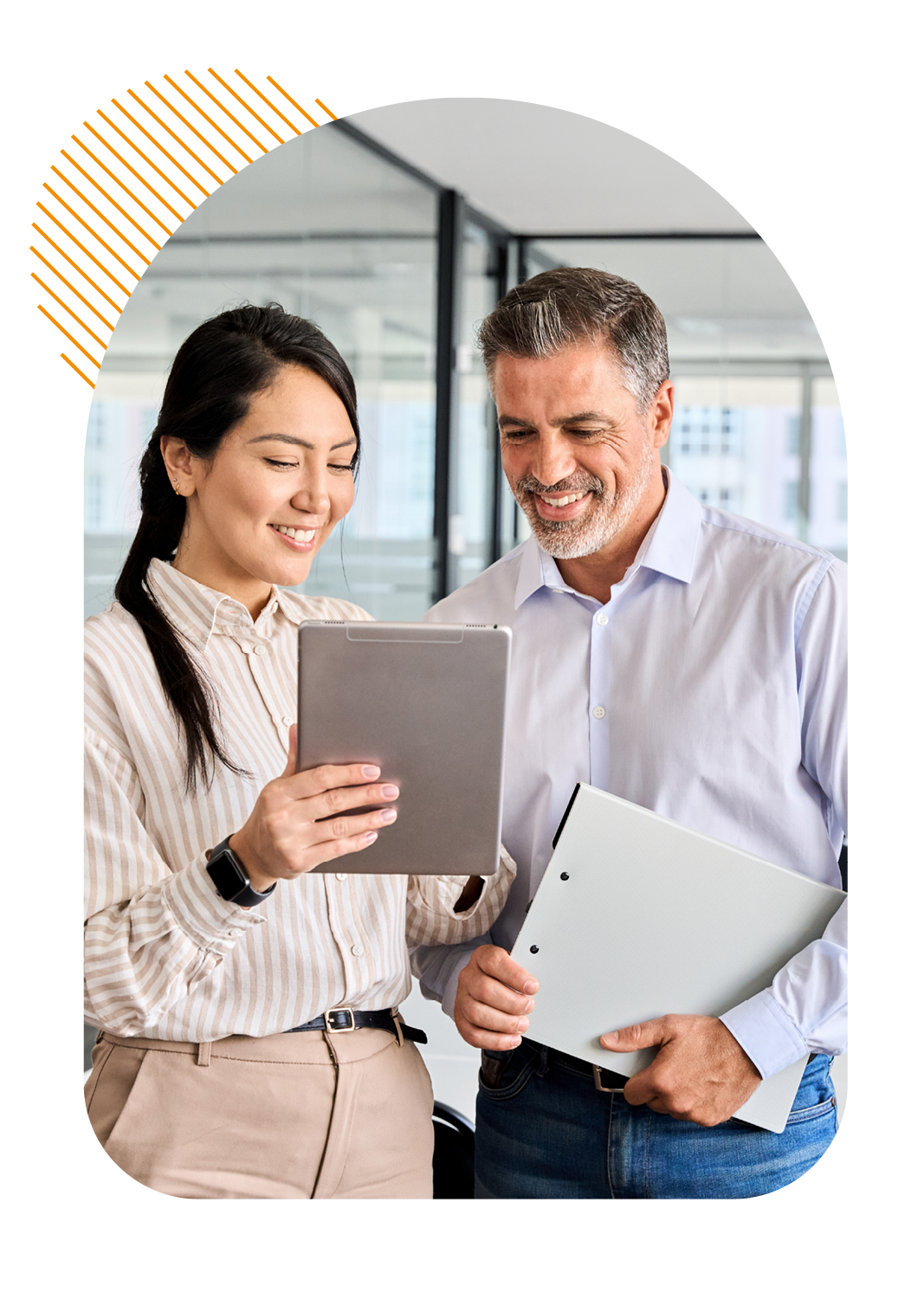 Two colleagues stood up viewing information on a tablet device