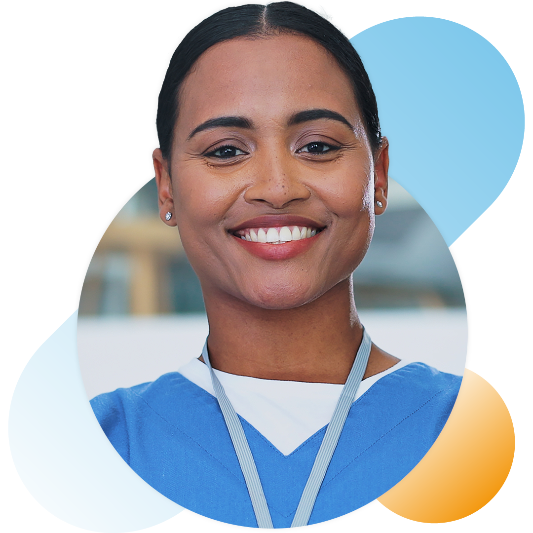 Image of a smiling doctor stood outside of a hospital